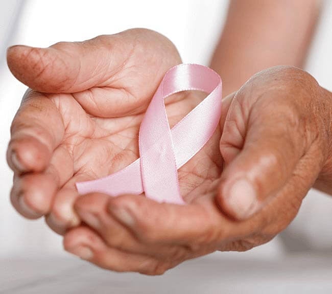Hands holding the pink breast cancer ribbon